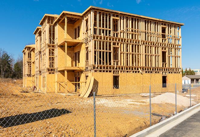 a close-up of temporary chain link fences enclosing a construction site, signaling progress in the project's development in Seneca SC